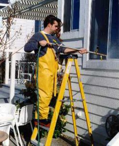 Technician from Interactive Resources, Inc. conducting AAMA 501.2, Field Check of Metal Storefronts, Curtain Walls, and Sloped Glazing Systems for Water Leakage