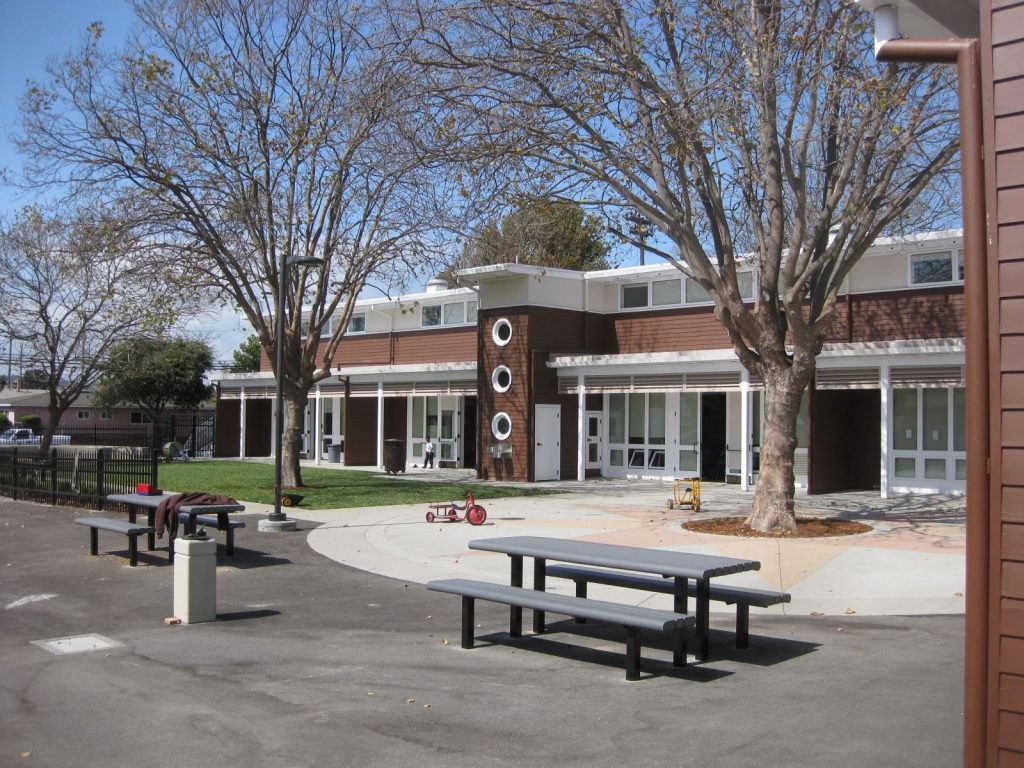 An exterior view of a one story historic brick school building