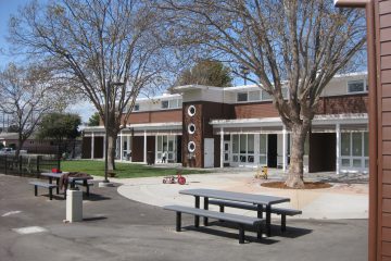 An exterior view of a one story historic brick school building